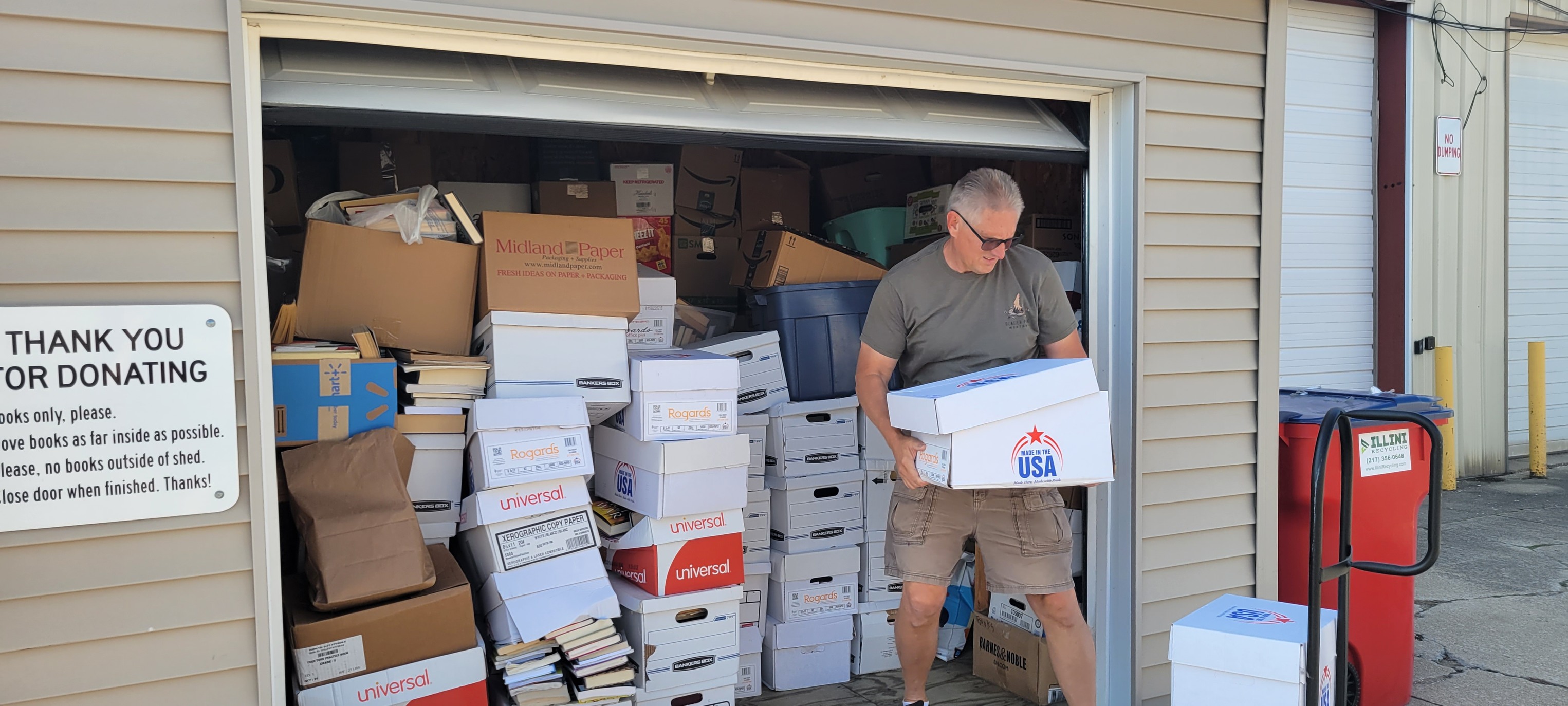 Bruce transfers books from the shed to the warehouse.